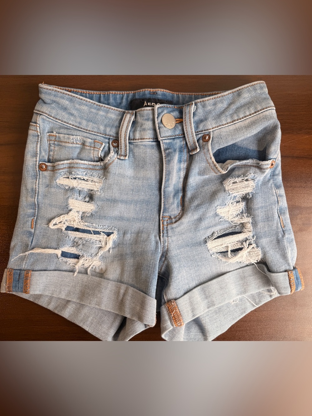 Aero high-rise midi blue denim shorts with distressed details size 0